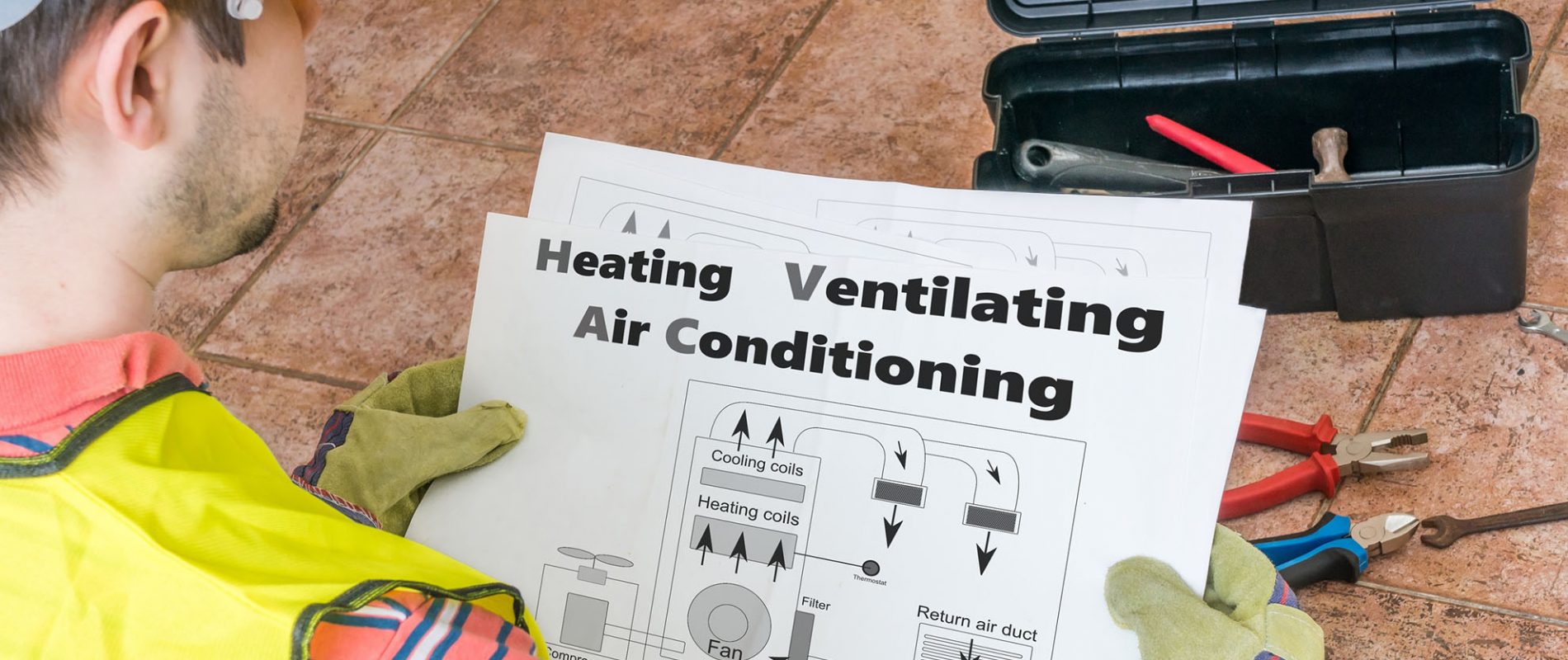 Repairman is looking at documentation of HVAC (Heating, Ventilat